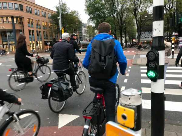 Zahlreiche Radfahrer überqueren die Strasse in Amsterdam.